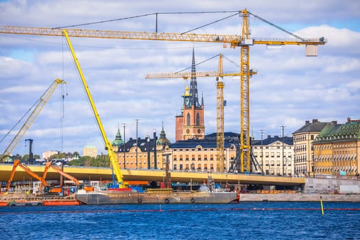 Cranes at Stockholm city Gamla Stan island construction site view, development of capital of Sweden