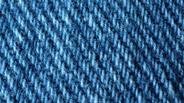 Macro shot of blue denim fabric. Professional factory seam on jeans pants. Casual wear, frayed material. Vintage texture surface of textile apparel. extreme close-up