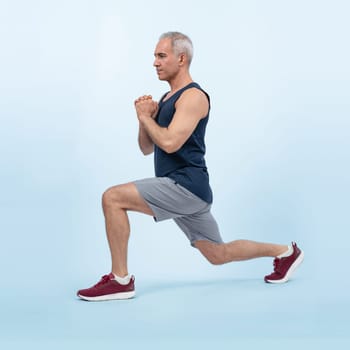 Active and fit physique senior man warming up before exercise on isolated background. Healthy lifelong senior people with fitness healthy and sporty body care lifestyle concept. Clout