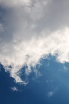 White clouds in bright blue sky close up