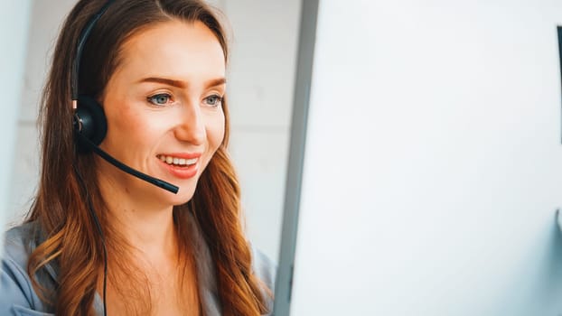 Business people wearing headset working in office to support remote customer or colleague. Call center, telemarketing, customer support agent provide service on telephone video conference call. Jivy