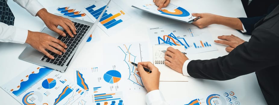 Business people in group meeting in formal attire share idea discussing report for company profit in creative workspace for start up business shot in close up view on group meeting table . Oratory .