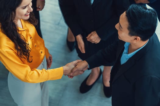 Businessmen shaking hand and making a contract in the sign of agreement, cooperation with businesswoman while smiling. Business people working together. Top view. Intellectual.