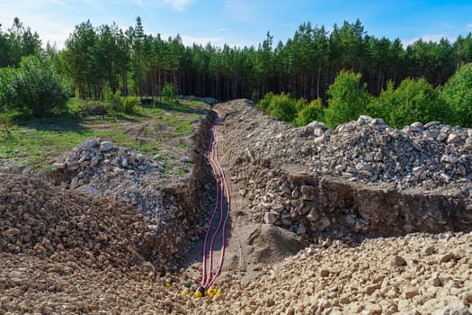 Laying High-Voltage Cables Underground Through the Forest to Connect Wind Turbines to the Power Grid.