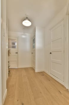 an empty room with white walls and wood flooring on the left side of the room, there is a door to the right