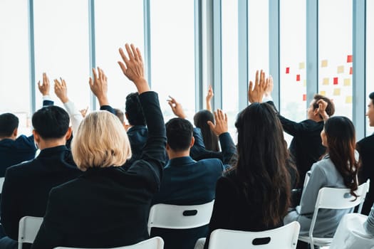 Group of business people meeting in a seminar conference . Audience listening to instructor in employee education training session . Office worker community summit forum with expert speaker . Jivy