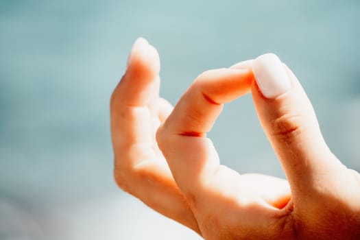 Close up Hand Gesture of Woman Doing an Outdoor Lotus Yoga Position. Close up. Blurred background