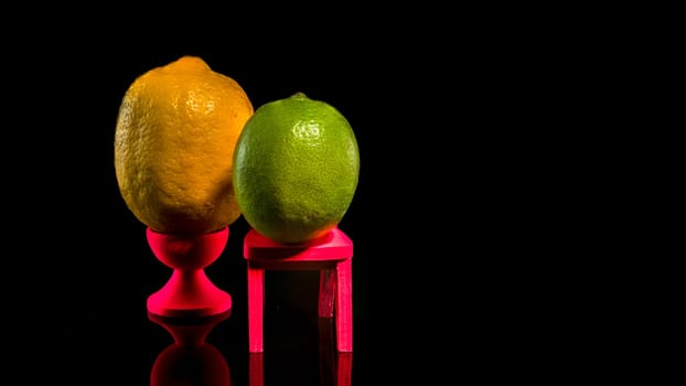 Creative still life with lemon and lime on a black background