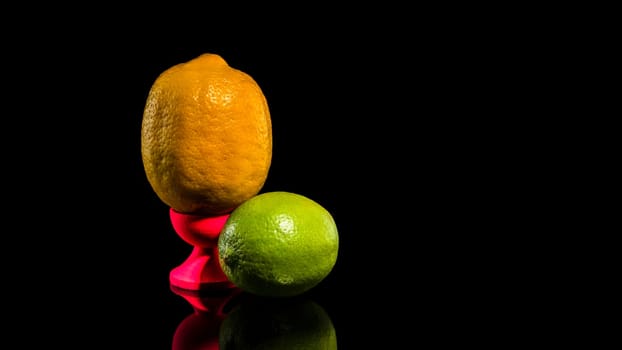 Creative still life with lemon and lime on a black background