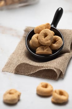 Taralli or tarallini traditional Italian snack in a bowl over an old gray wooden table. Rustic shot of taralli appetizer.