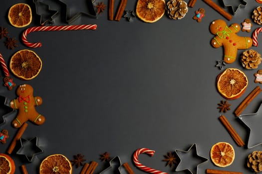 Christmas food frame. Gingerbread cookies, spices and decorations on gray background with copy space