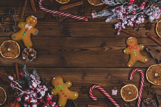 Christmas flat lay background with traditional gingerbread cookies dried orange cinnamon on wood , copy space for text