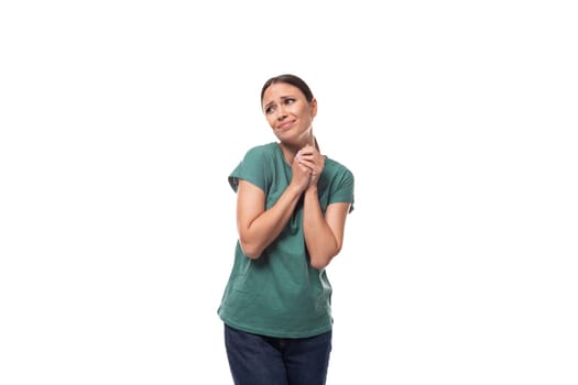 a young woman with black hair and a slender figure dressed in a green T-shirt hopes for good luck.