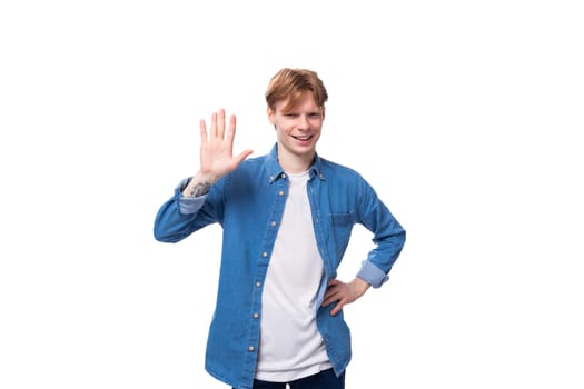 young friendly man with red hair in a blue shirt and white t-shirt.