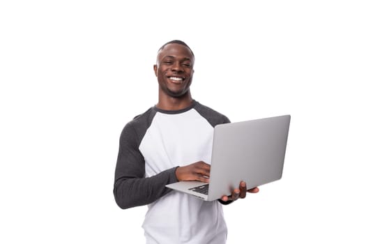 young african man working remotely in the field of IT and using a laptop.