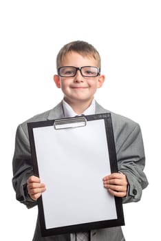 Small child dressed in a business suit and glasses as a businessman with clipboard. Child in his fathers suit and blank paper sheet in clipboard isolated on white background.