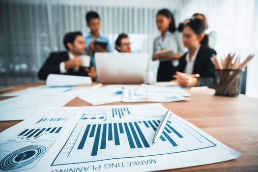 Piles of analyzed financial data dashboard on meeting table with background of business people analyzing data analysis market trend indication for strategic marketing investment plan. Habiliment