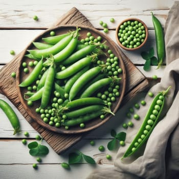 Fresh green peas in bowl with pods and leaves on white wooden table, healthy green vegetable or legume.