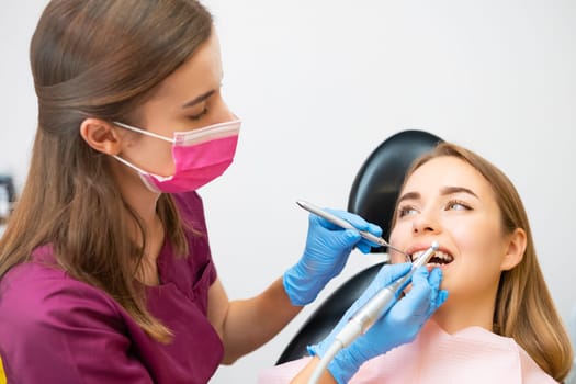 Woman having teeth examination at dentists office.