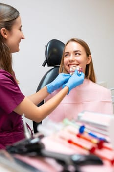 The dentist chooses the ideal shades of white to enhance the patients smile.