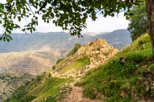 Dagestan Gamsutl. Ancient ghost town of Gamsutl old stone houses in abandoned Gamsutl mountain village in Dagestan, Abandoned etnic aul, summer landscape