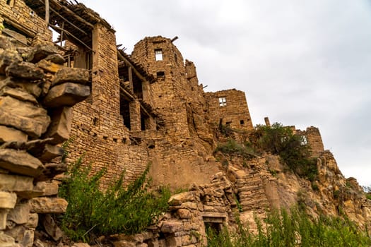 Dagestan Gamsutl. Ancient ghost town of Gamsutl old stone houses in abandoned Gamsutl mountain village in Dagestan, Abandoned etnic aul, summer landscape