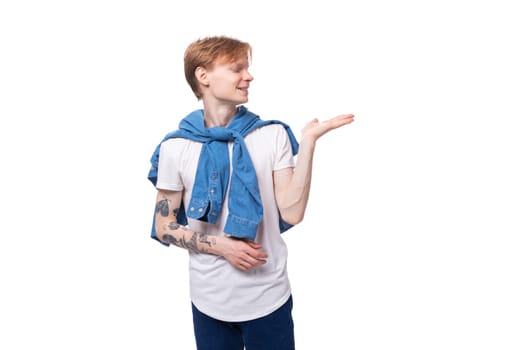 young cute caucasian guy with short red hair with a tattoo on his arms actively gesturing.