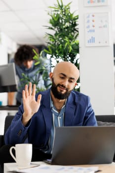 Project manager attending video conference to discuss strategy with clients online. Corporate worker talking about product launch during virtual meeting with customer via webcam