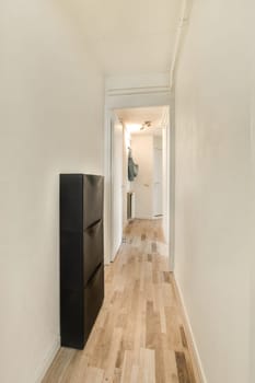 a long hallway with wood flooring and white walls in the room is very clean, but it's hard to see how