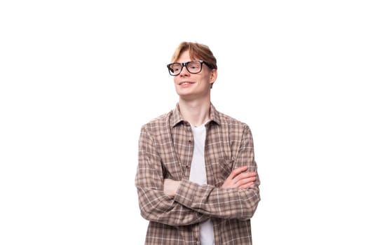 young stylish european student man with golden hair wearing glasses and a plaid shirt.