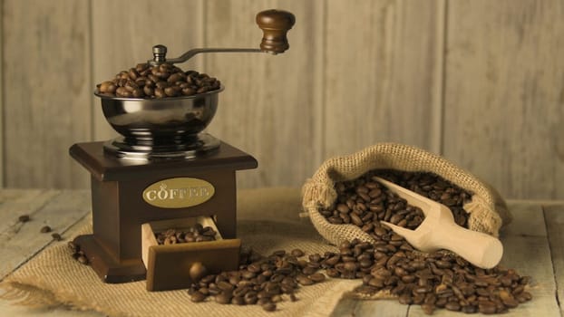 Coffee beans on old fashioned wooden table.
