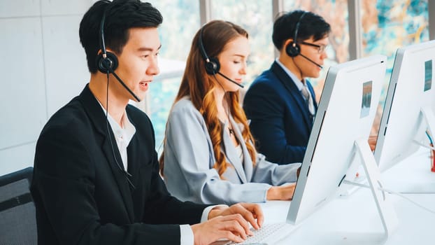 Business people wearing headset working in office to support remote customer or colleague. Call center, telemarketing, customer support agent provide service on telephone video conference call. Jivy