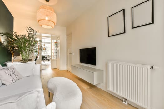 a living room with two white chairs and a television on the wall in front of the tv is mounted to the wall