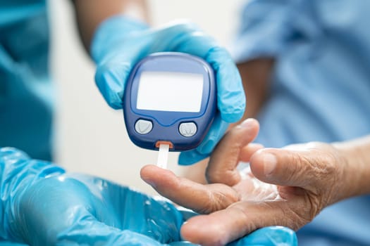 Doctor check diabetes from finger blood sugar level with finger lancet.