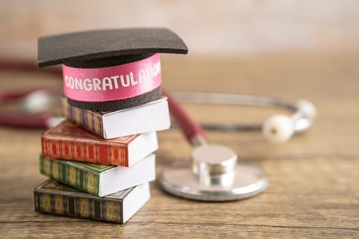 Stethoscope with graduation hat on book with copy space, learning university education concept.