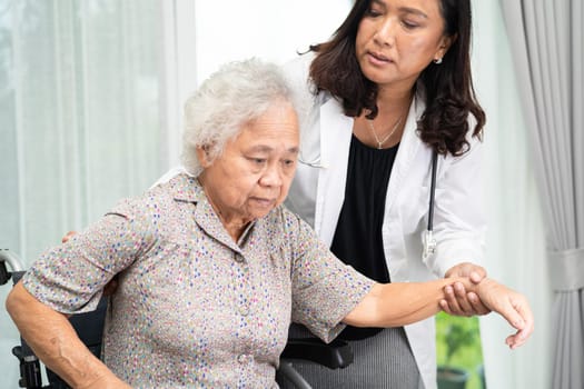 Caregiver help Asian senior woman on wheelchair.