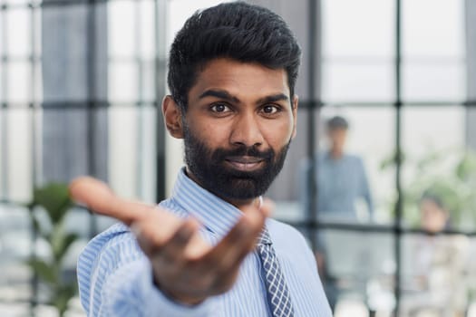 male investor beard looking at camera and smiling in modern office