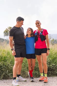 happy family looking at camera after doing sports in the countryside, concept of active lifestyle and sport with kids in the nature