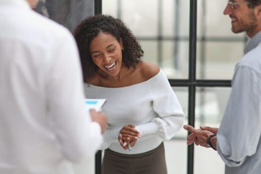 Negotiations in the office. Cheerful business woman talking with colleagues