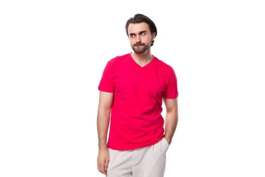 young black-haired european man dressed in red corporate t-shirt with logo print mockup.