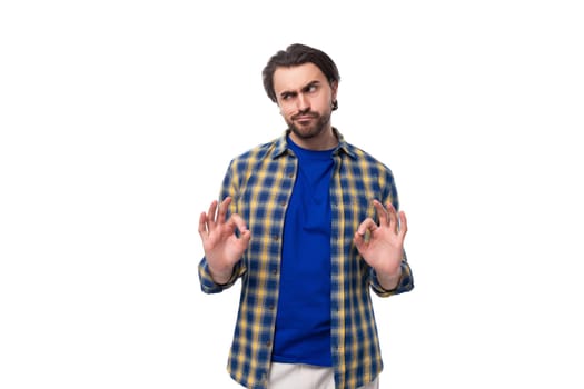 young caucasian brutal man with unshaven face dressed in blue plaid shirt isolated on white background with copy space.