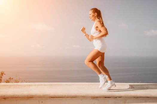 Fitness woman sea. Outdoor workout on yoga mat in park near to ocean beach. Female fitness pilates yoga routine concept. Healthy lifestyle. Happy fit woman exercising with rubber band in park.