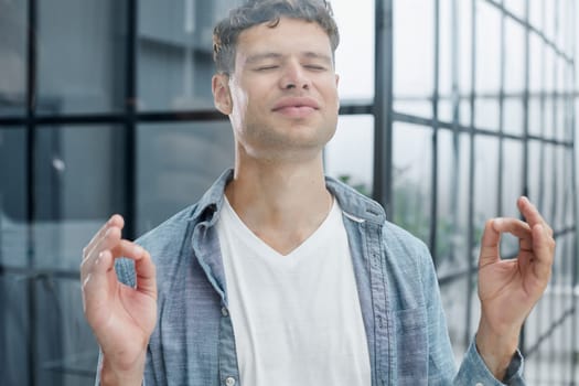 man resting in office relaxing, businessman meditating in lotus position