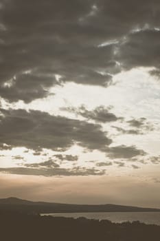 Abstract background sky Dawn Sunset Contrast dark shadow bright cloud sun orange silhouette above the mountains near the sea.