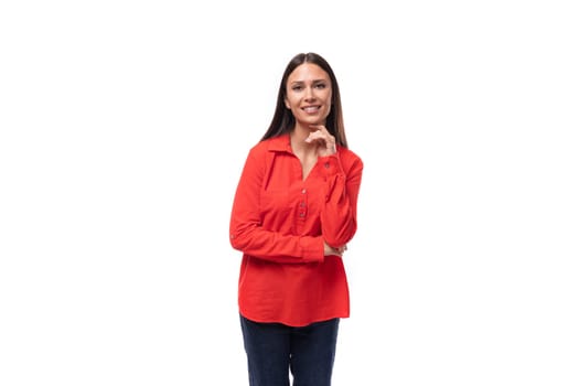 young caucasian model woman with straight black hair dressed in a red blouse on a white background.