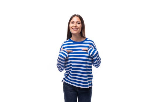 pretty young smiling brunette woman in a striped blue sweatshirt on a white background.