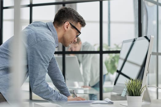 man working making notes in his planner