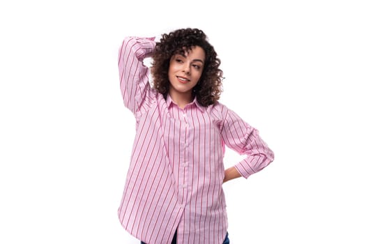 young caucasian leader woman with a curly haircut is dressed in a pink shirt on a white background.
