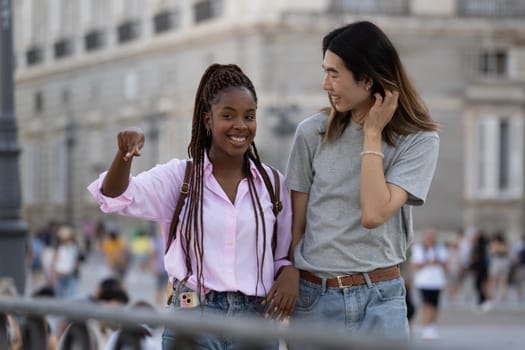 Multi ethnic couple of friends sharing time together. They are smiling and indicating where to go next.