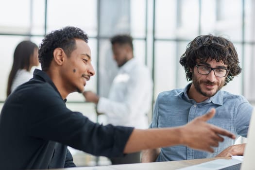 Business professionals collaborating happily in a modern office with technology.